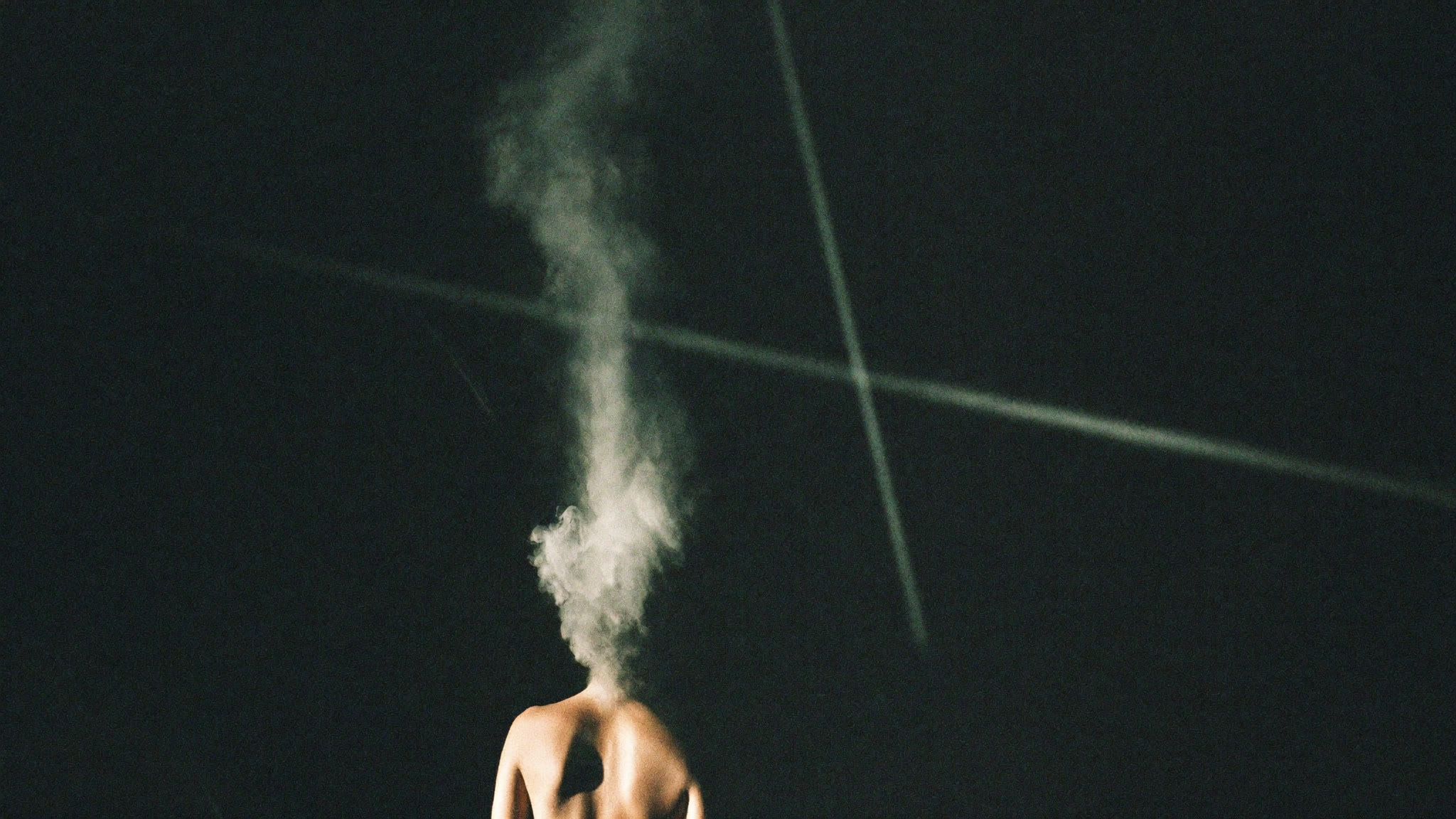 HORS-VUE campaign film still — a figure dissolving into champagne vapour.